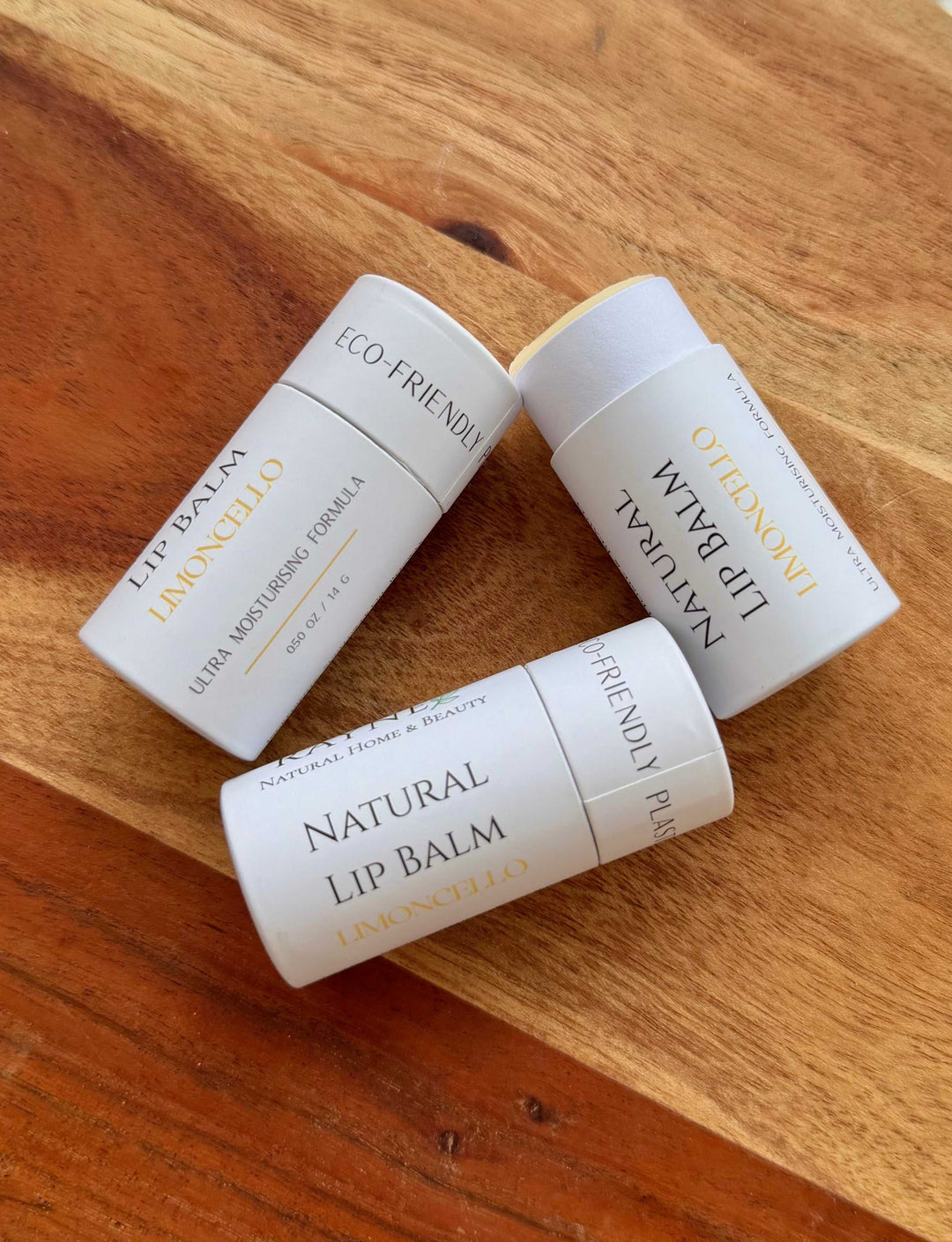 Natural lip balm tubes, white packaging labeled Natural Lip Balm and ECO FRIENDLY