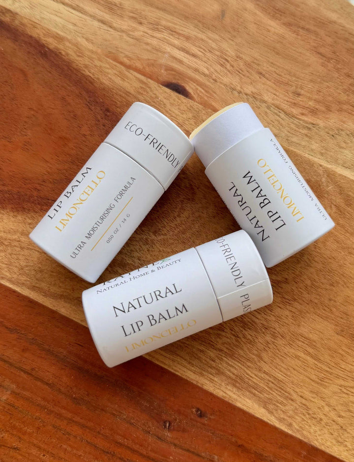 Natural lip balm tubes, white packaging labeled Natural Lip Balm and ECO FRIENDLY