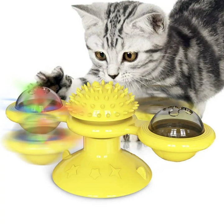 Spinning windmill cat toy in yellow with clear glowing LED domes; with tabby cat