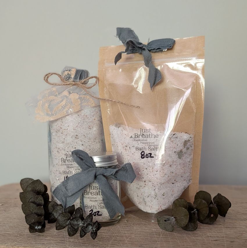 Pack of bath salt sachets labeled "Just Breathe" with blue ribbon bow