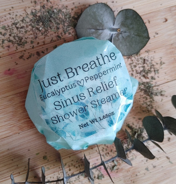 Eucalyptus peppermint shower steamer in turquoise wrapper with leaf accents