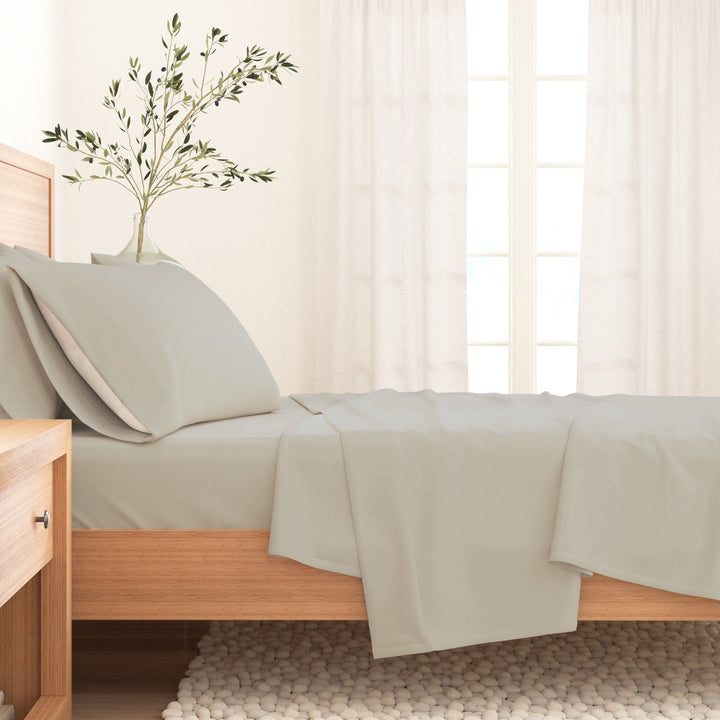 Cotton solid flannel sheet set in warm off-white on a bed with pillow