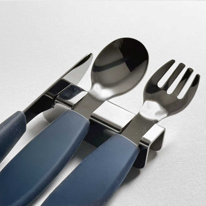 Stainless steel kids flatware rest holding a blue-handled spoon and fork