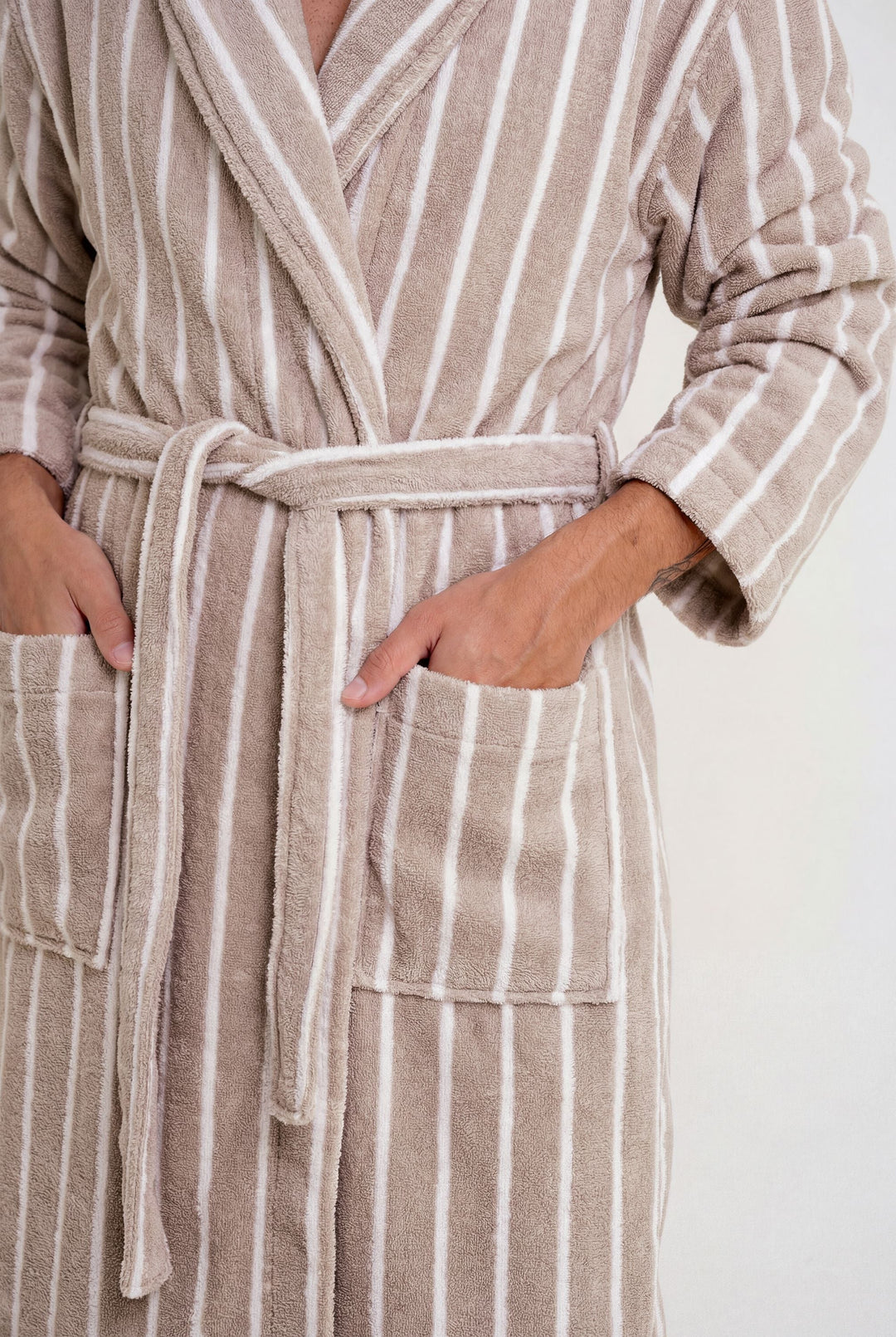 Striped bathrobe with tied belt and front patch pockets, close-up