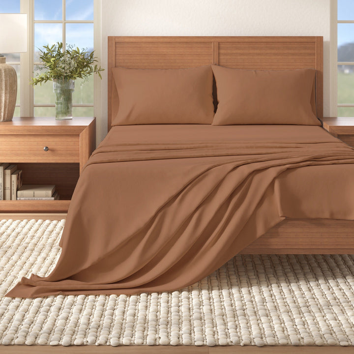 Solid cotton flannel sheet set in camel brown on a bed, neatly layered bedding