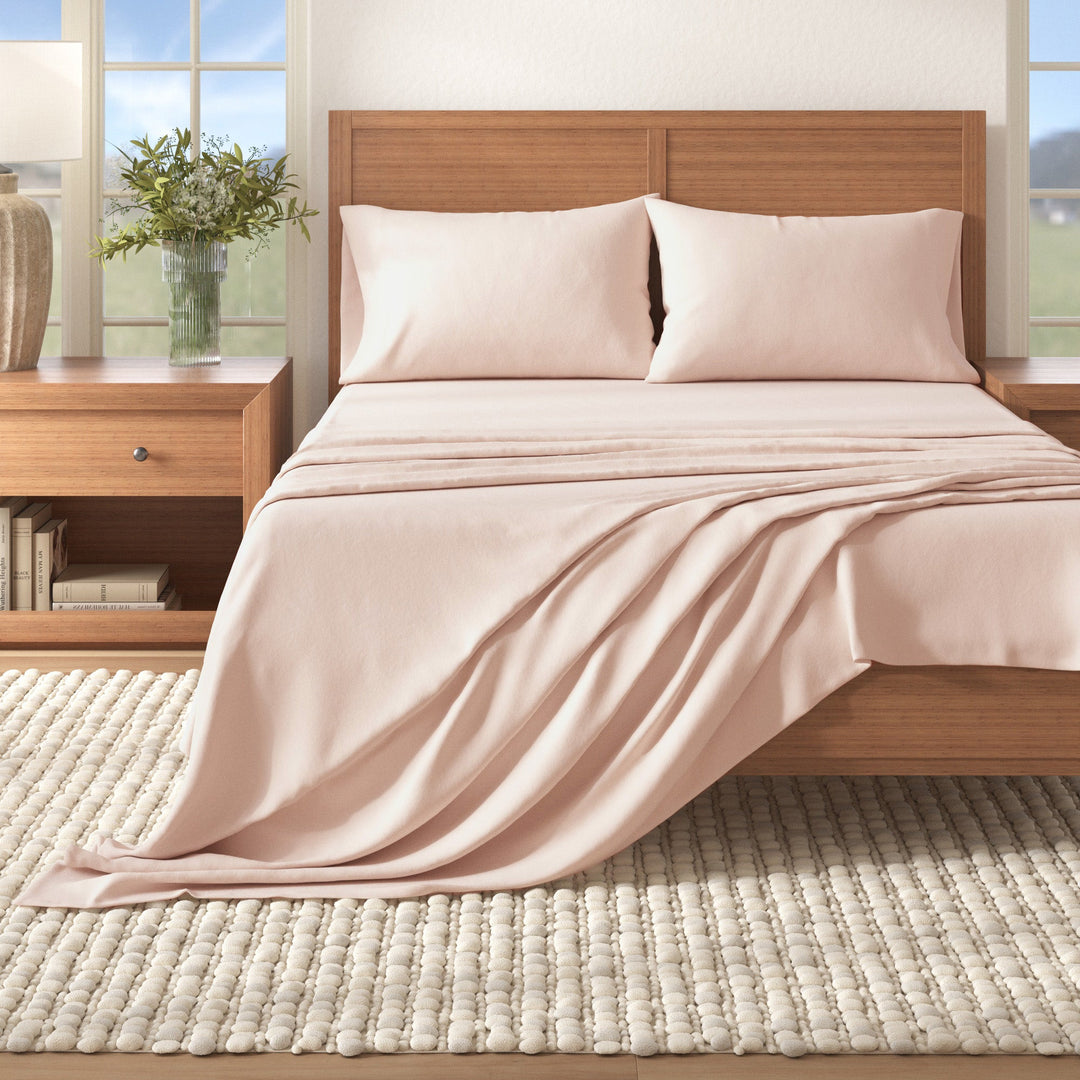 Cotton flannel sheet set in blush pink on bed with matching pillowcases