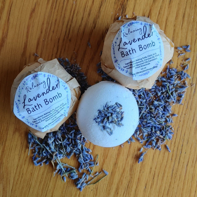 Set of three round lavender bath bombs with printed labels and dried lavender on top
