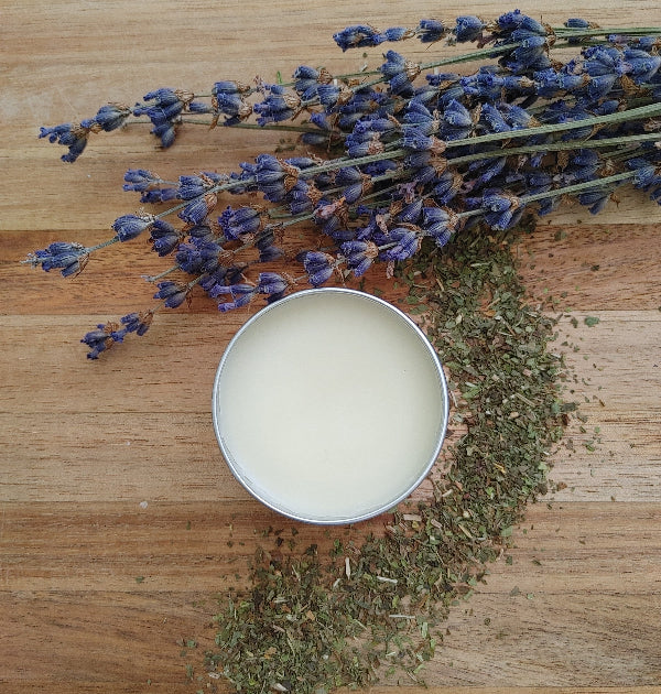 Round tin lip balm with pale cream balm inside