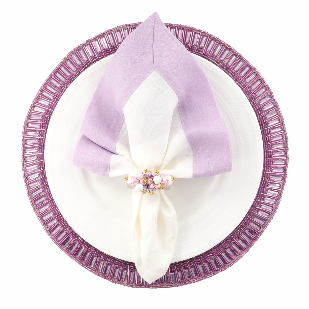 Lilac linen napkins with double-sided border, folded over center and layered