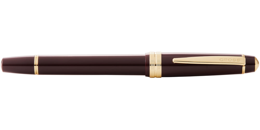 Burgundy resin rollerball pen with gold-tone clip and CROSS logo on barrel