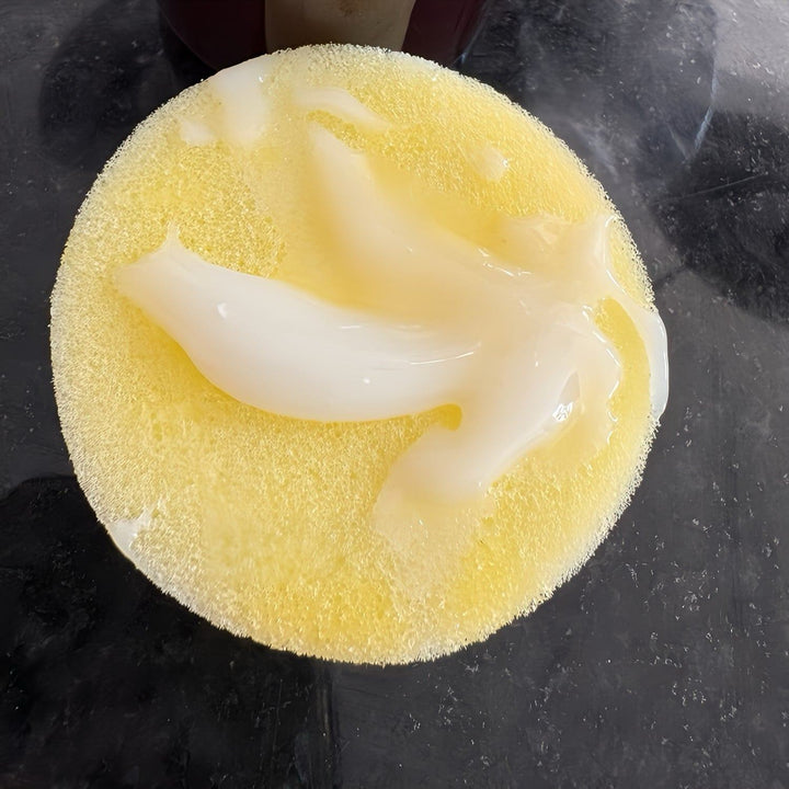 Yellow sponge with cream cleaner and sanitizer solution