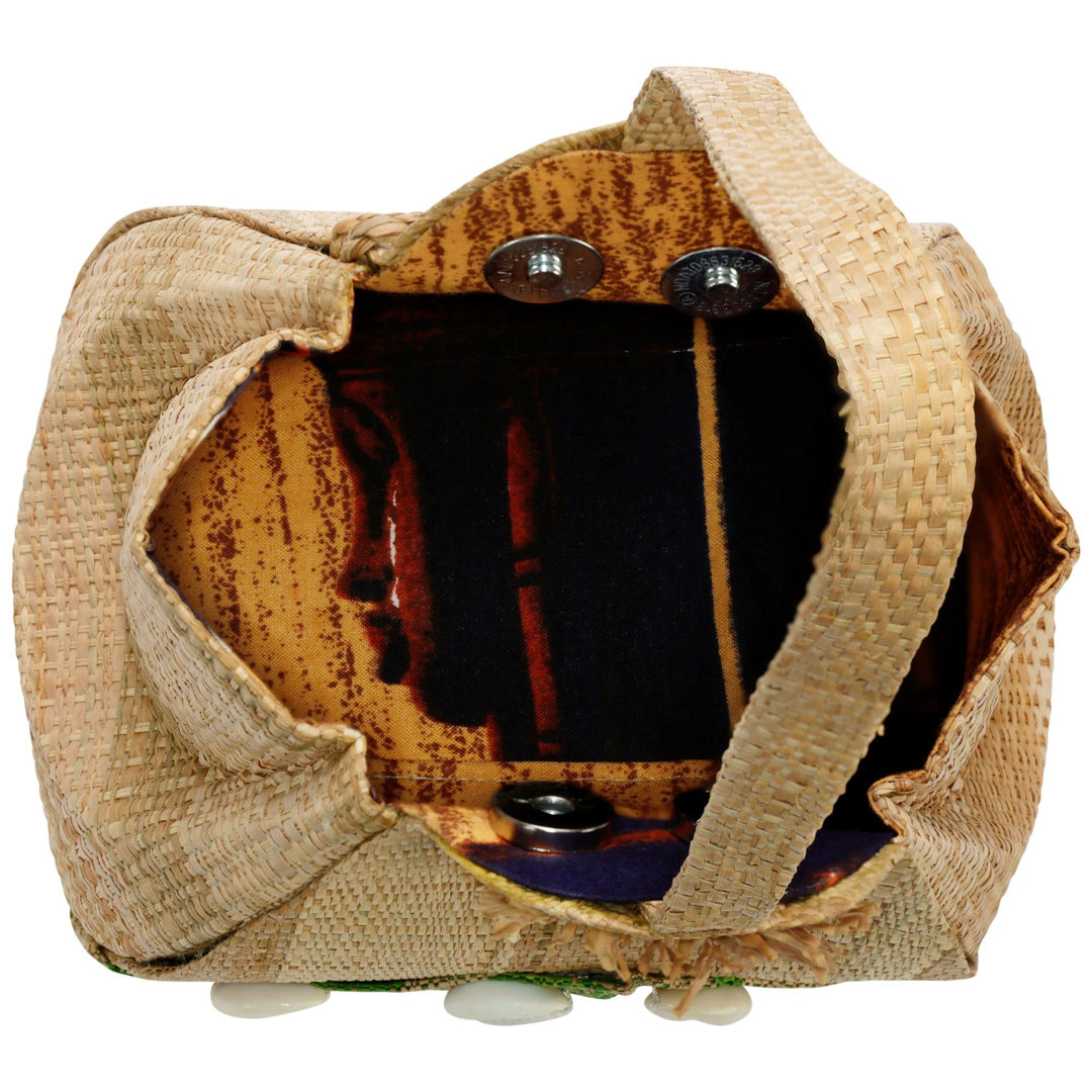 Raffia bag interior with tan lining and dark striped pocket, snap closure