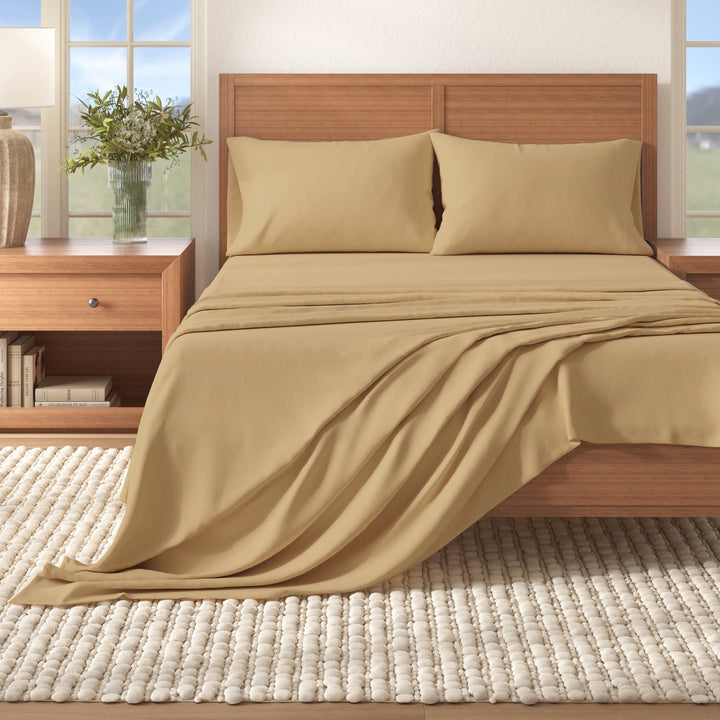 Camel cotton flannel sheet set on a bed with two pillows and draped throw