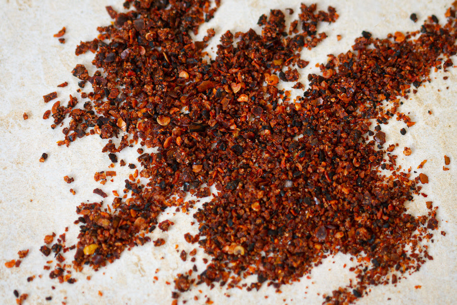 Ground chili-lime seasoning, dark red-brown specks in a small pile
