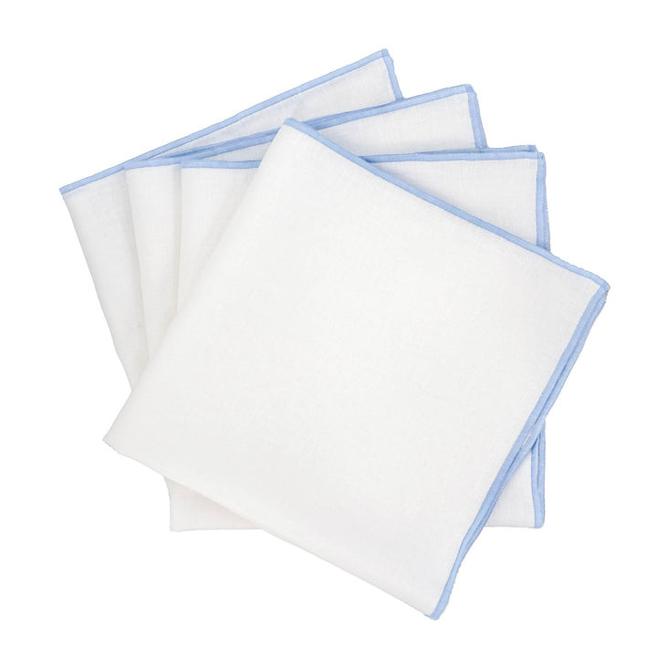 Set of four linen napkins, white with blue stitched edges, folded squares