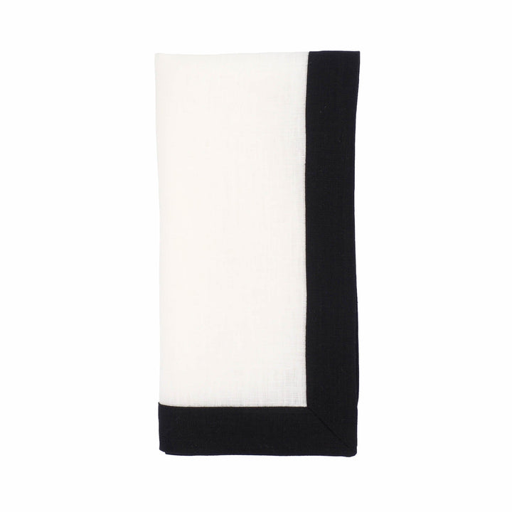Single folded linen napkin with white center and vertical black side border.
