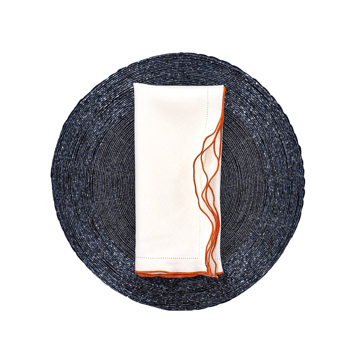 White linen napkin with orange ruffled hemstitch edge, folded rectangle