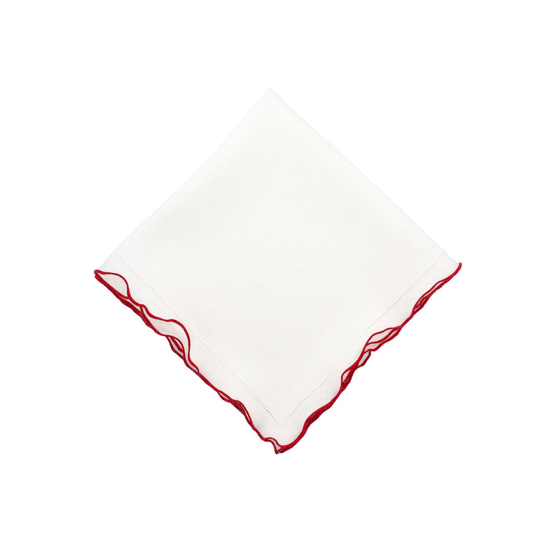 White linen napkin with red ruffled hemstitch edges, square folded