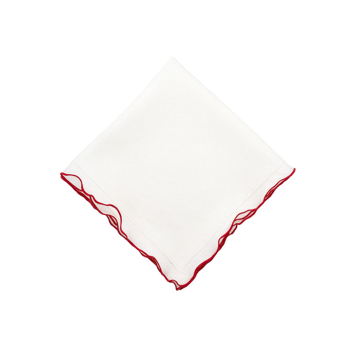 White linen napkin with red ruffled hemstitch edges, square folded