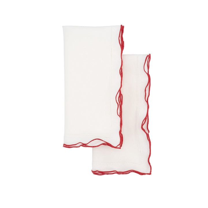 White linen napkins with red ruffled hemstitch edges, two folded pieces