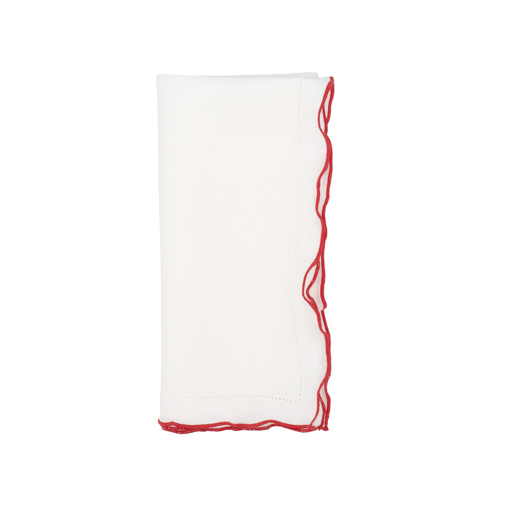 White linen napkin with red ruffled hemstitch edge detail, folded