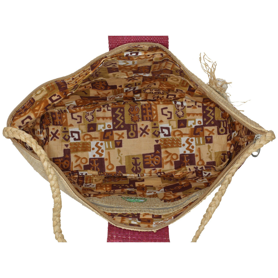 Raffia tote bag interior with patterned fabric lining and rope handle edges.