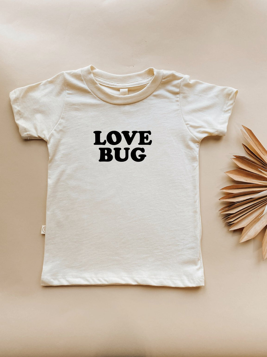 Off-white kids organic T-shirt with "LOVE BUG" black chest graphic