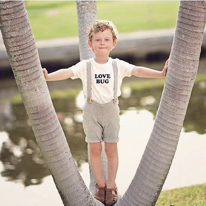Off-white kids organic T-shirt with "LOVE BUG" black chest graphic