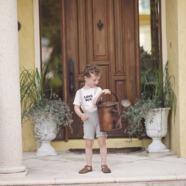 Off-white kids organic T-shirt with "LOVE BUG" front graphic