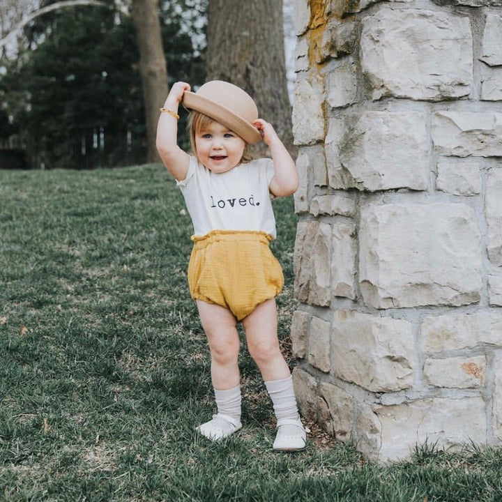 Kids organic T-shirt with “loved.” print at center chest and crew neck