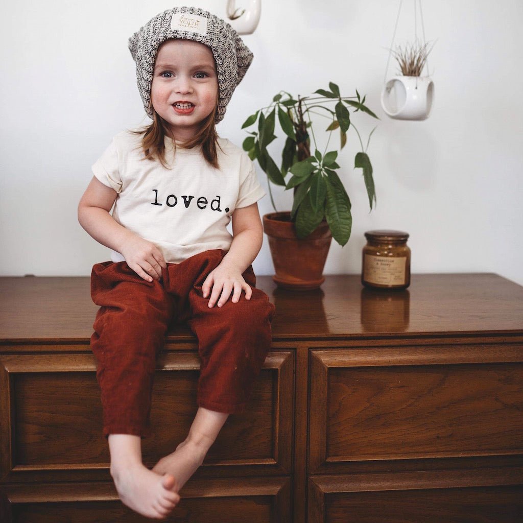 Kids organic T-shirt with “loved.” text print on chest and short sleeves