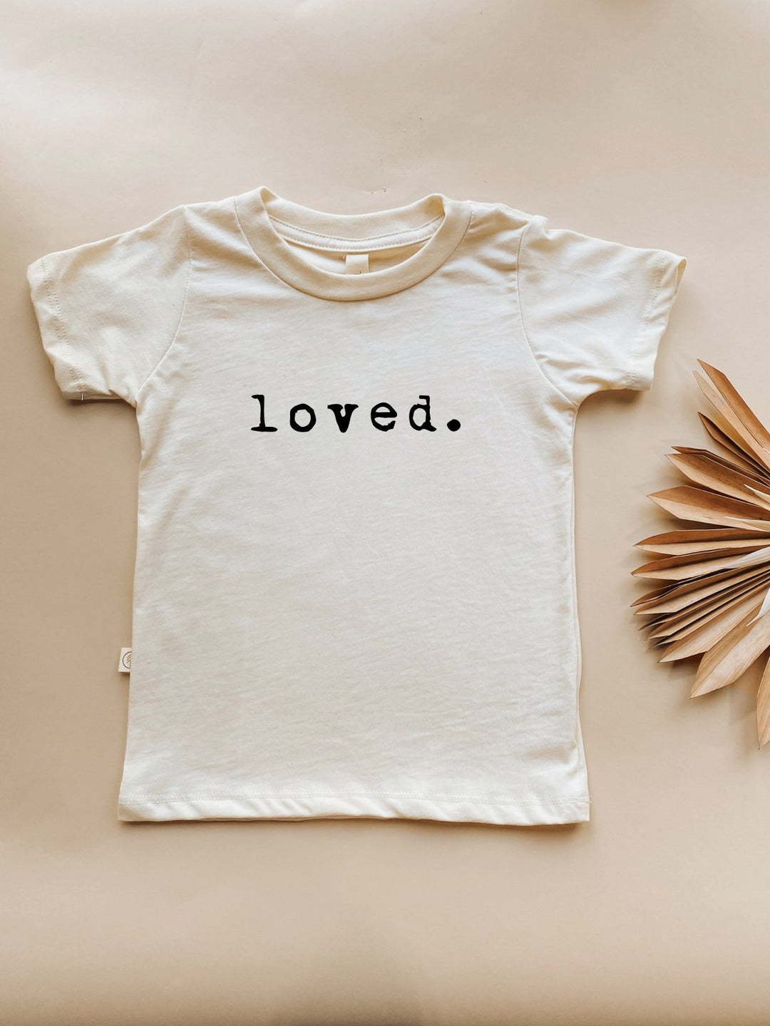 Cream kids organic T-shirt with short sleeves and “loved.” text print