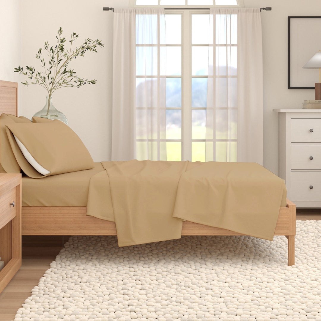 Camel cotton flannel sheet set on a bed with folded flat sheet and pillow