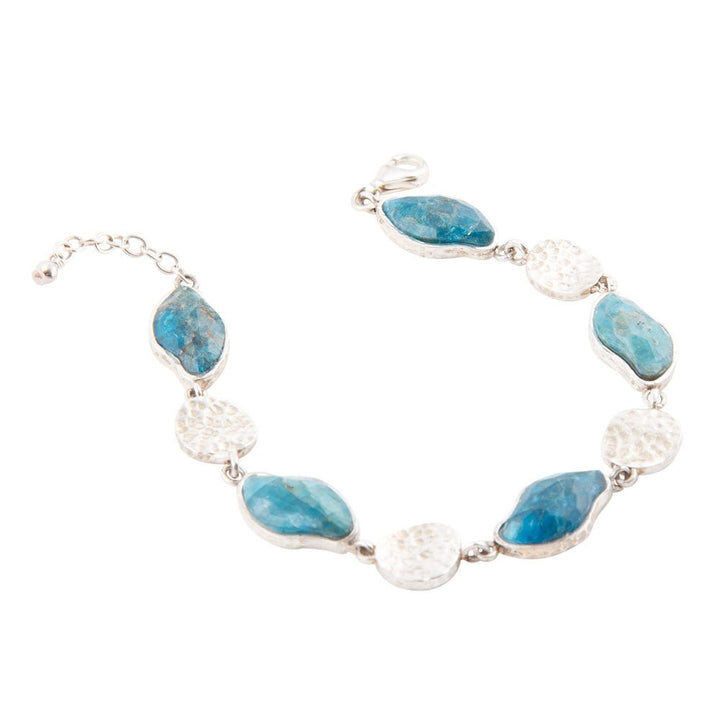 Sterling silver line bracelet with blue apatite oval stones and textured round bead links