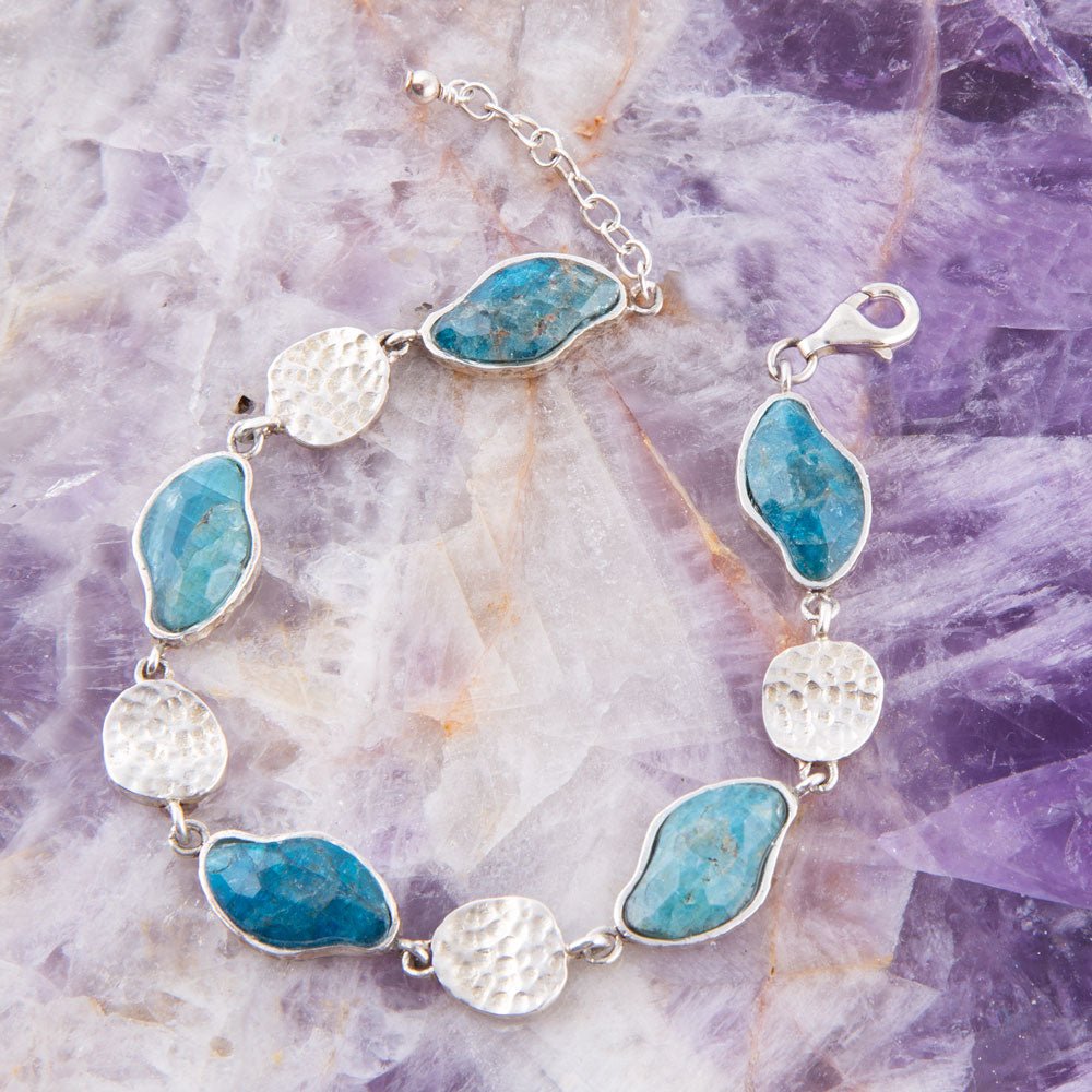 Sterling silver bracelet featuring blue apatite marquise stones with hammered disc accents