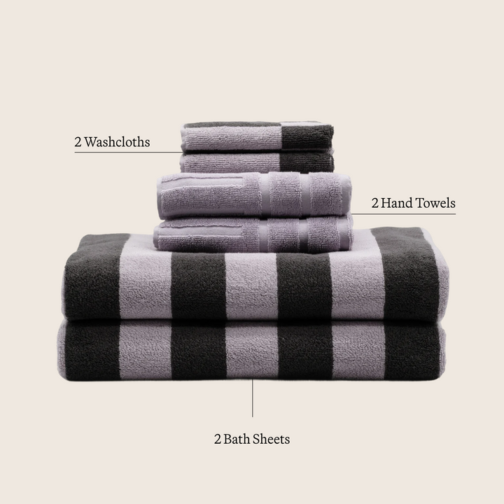Cream and gray striped cotton towels stacked, including a large bath sheet.