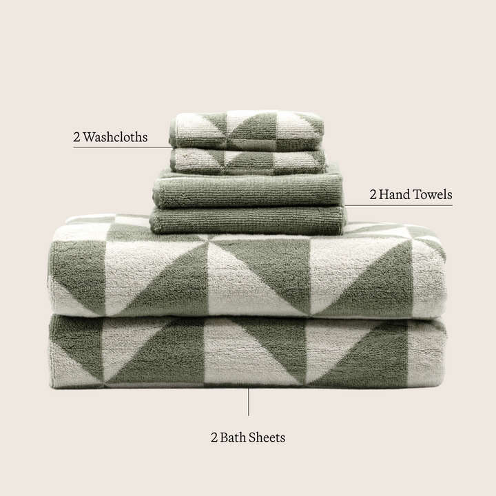 Stacked sage-green cotton towels with white diamond pattern, set layout view