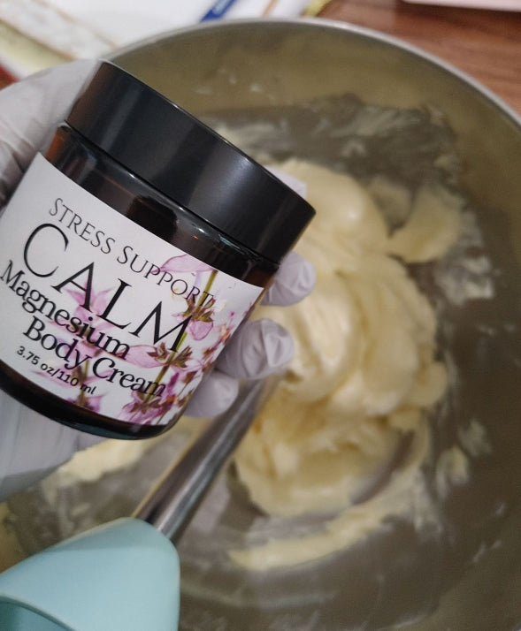 Magnesium body cream jar held in glove beside cream mixture in bowl