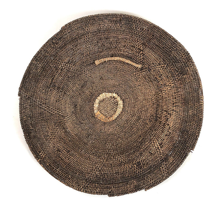 Small round woven basket with concentric weave and circular stitched detail on top