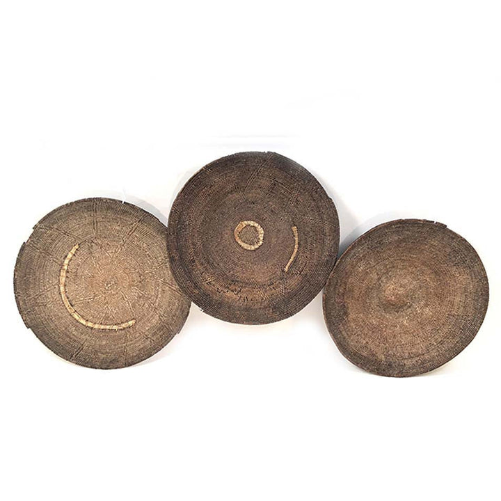 Set of three round woven baskets in varying sizes, nested together