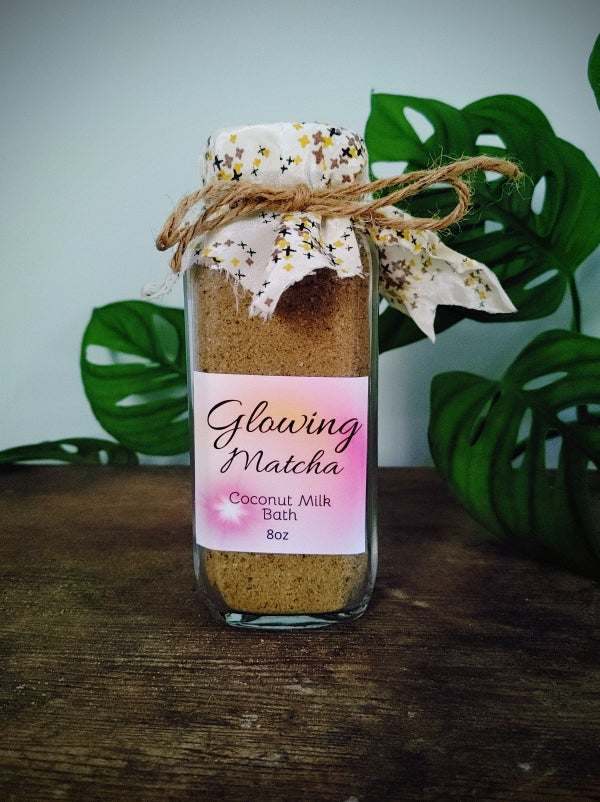 Glowing matcha coconut milk bath soak in glass jar with bow ribbon label