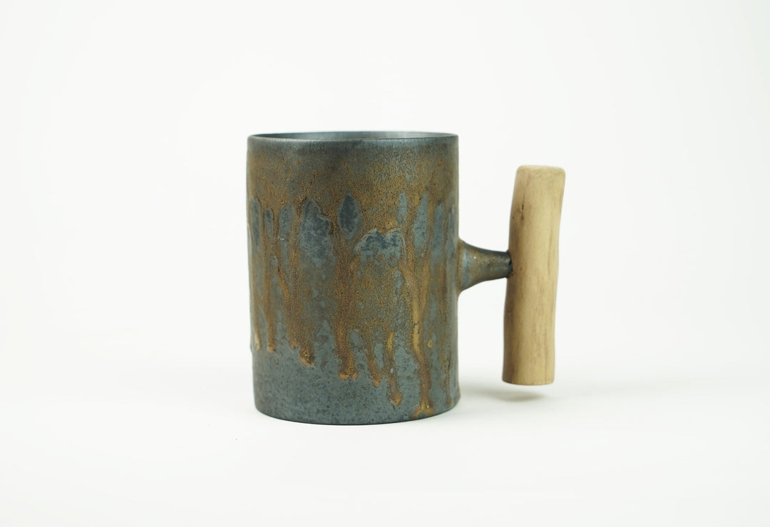 Iron bronze glazed ceramic mug with wooden handle, side view