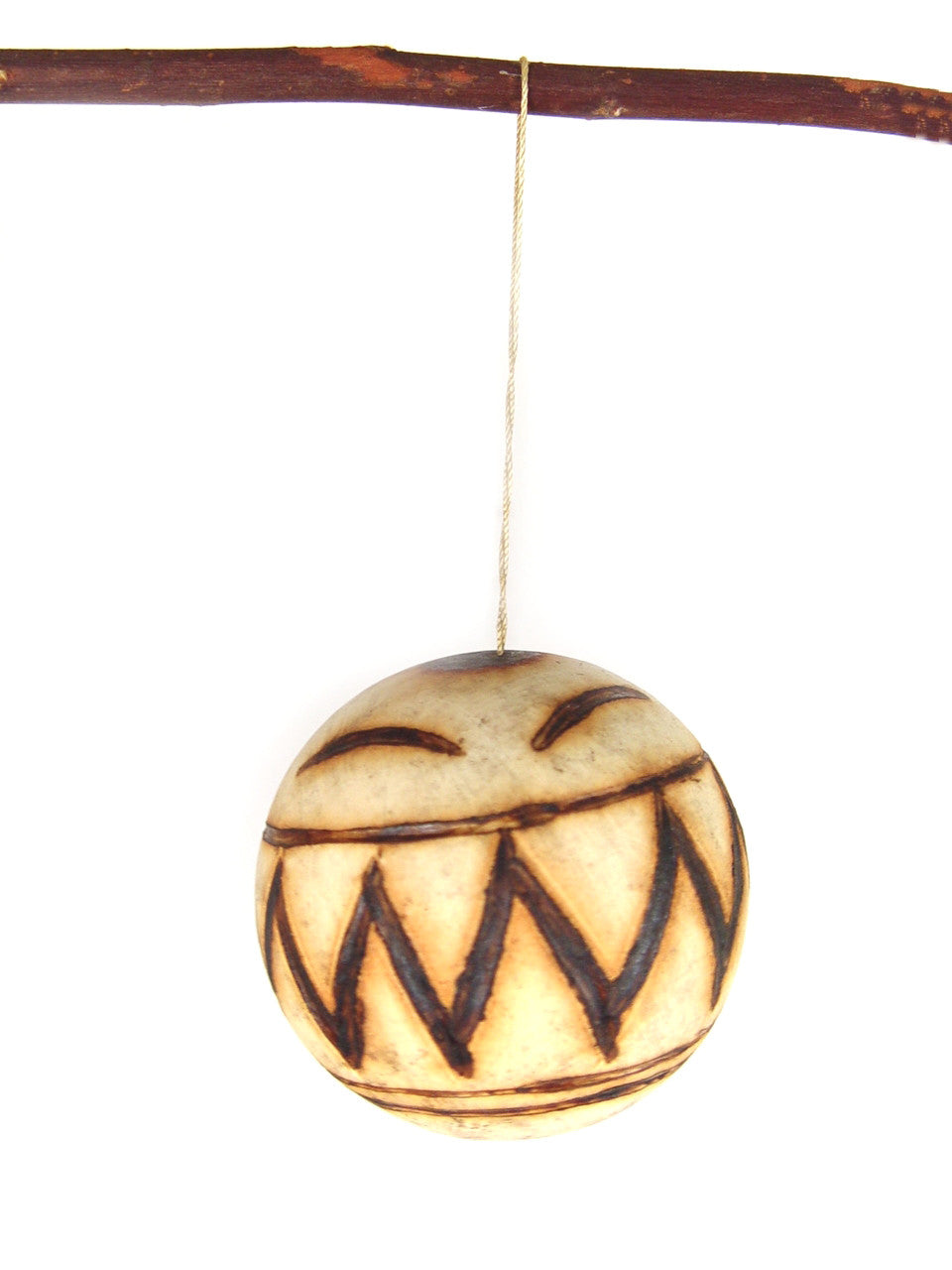 Marula fruit ornament: single round carved wooden bauble with zigzag tribal face pattern