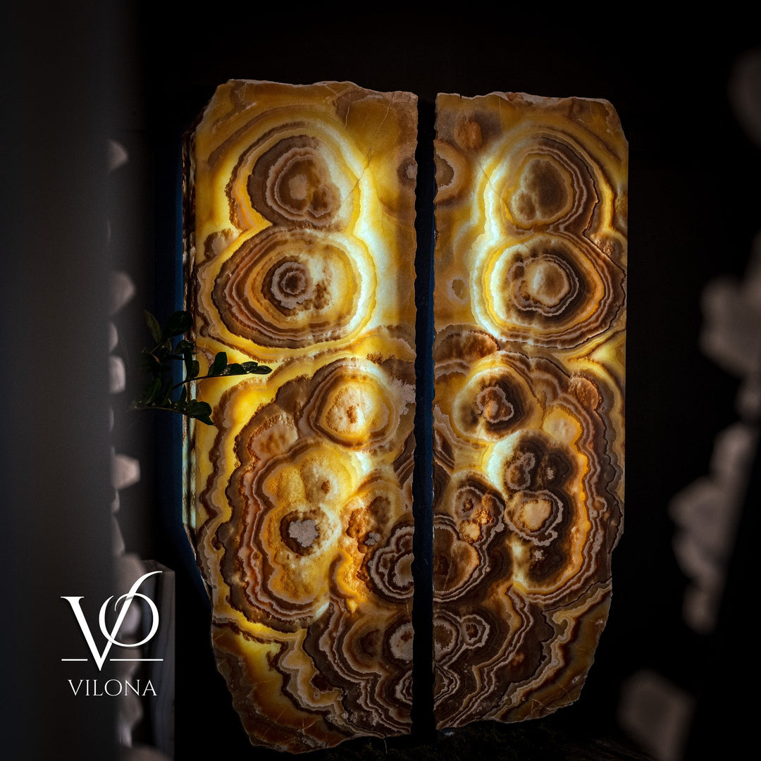 Onyx wall panel set with glowing circular bands and dark brown stone streaks.
