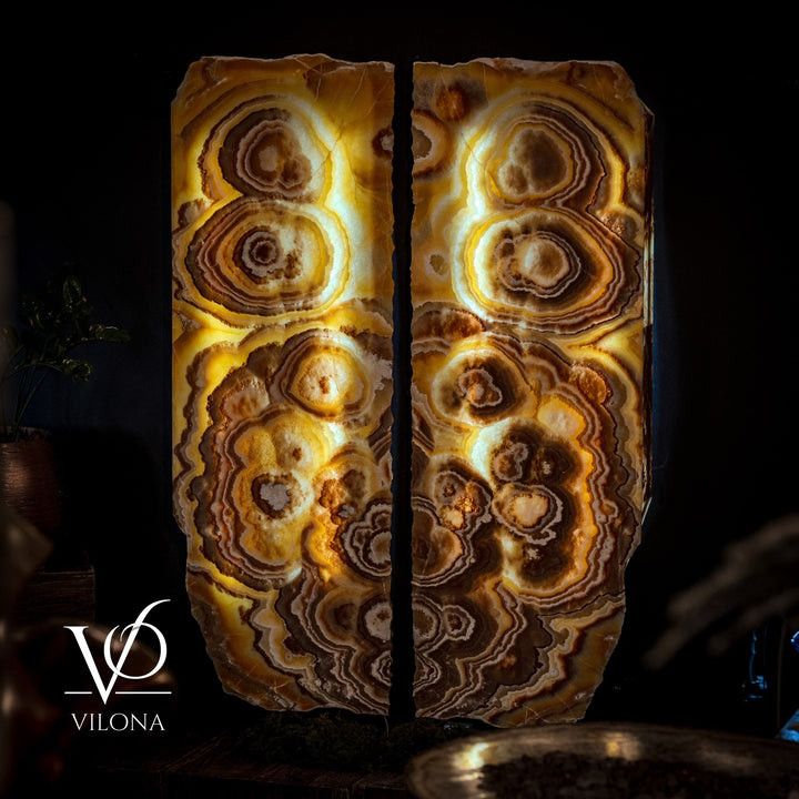 Onyx wall panel set with glowing gold and brown swirl patterns, paired panels.