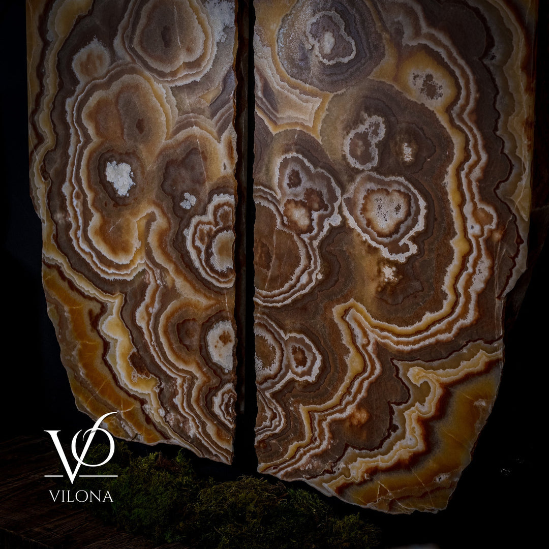 Onyx wall panel set with dark brown, gold, and white swirling stone pattern.