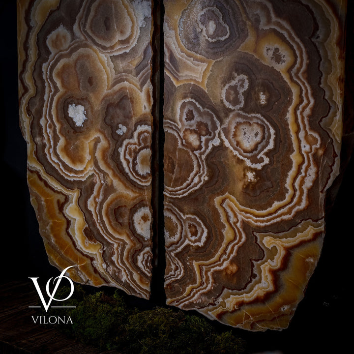 Onyx wall panel set with dark brown, gold, and white swirling stone pattern.