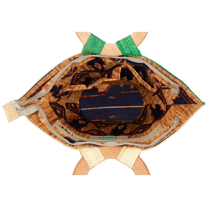 Open green-and-tan raffia tote bag with wooden ring handles, patterned interior