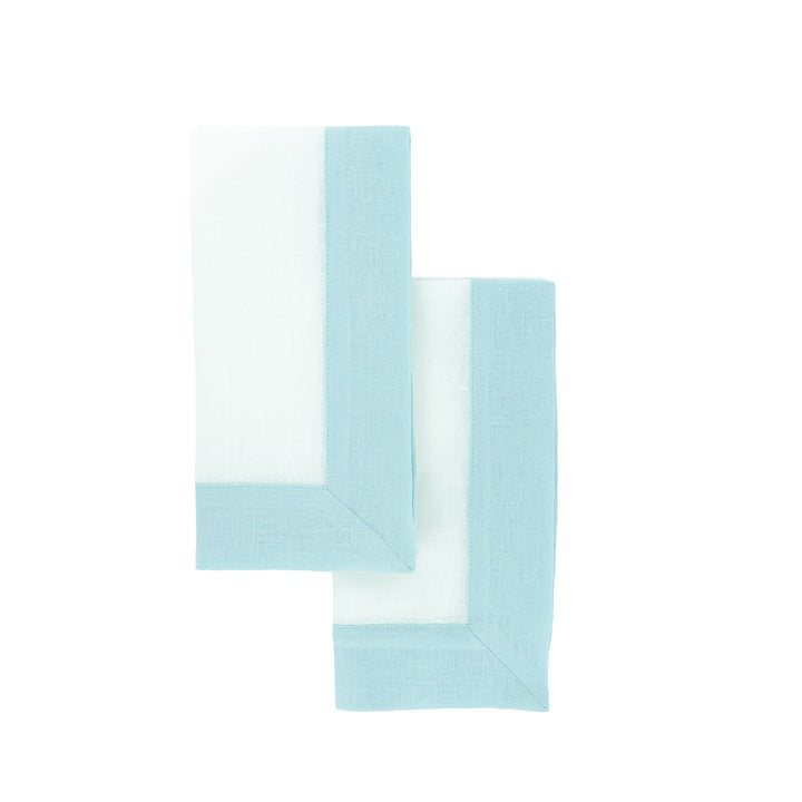 Two mint linen napkins overlapping, showing light green border along corners