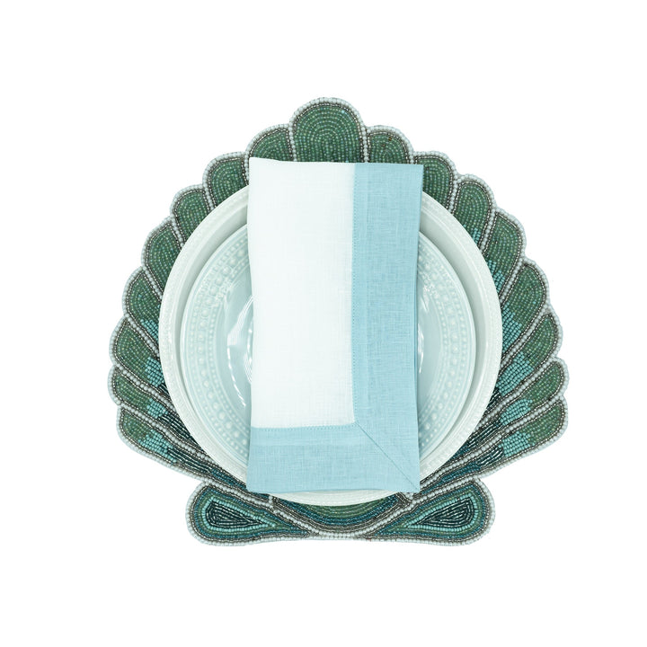 Mint linen napkin folded upright with light green border panel
